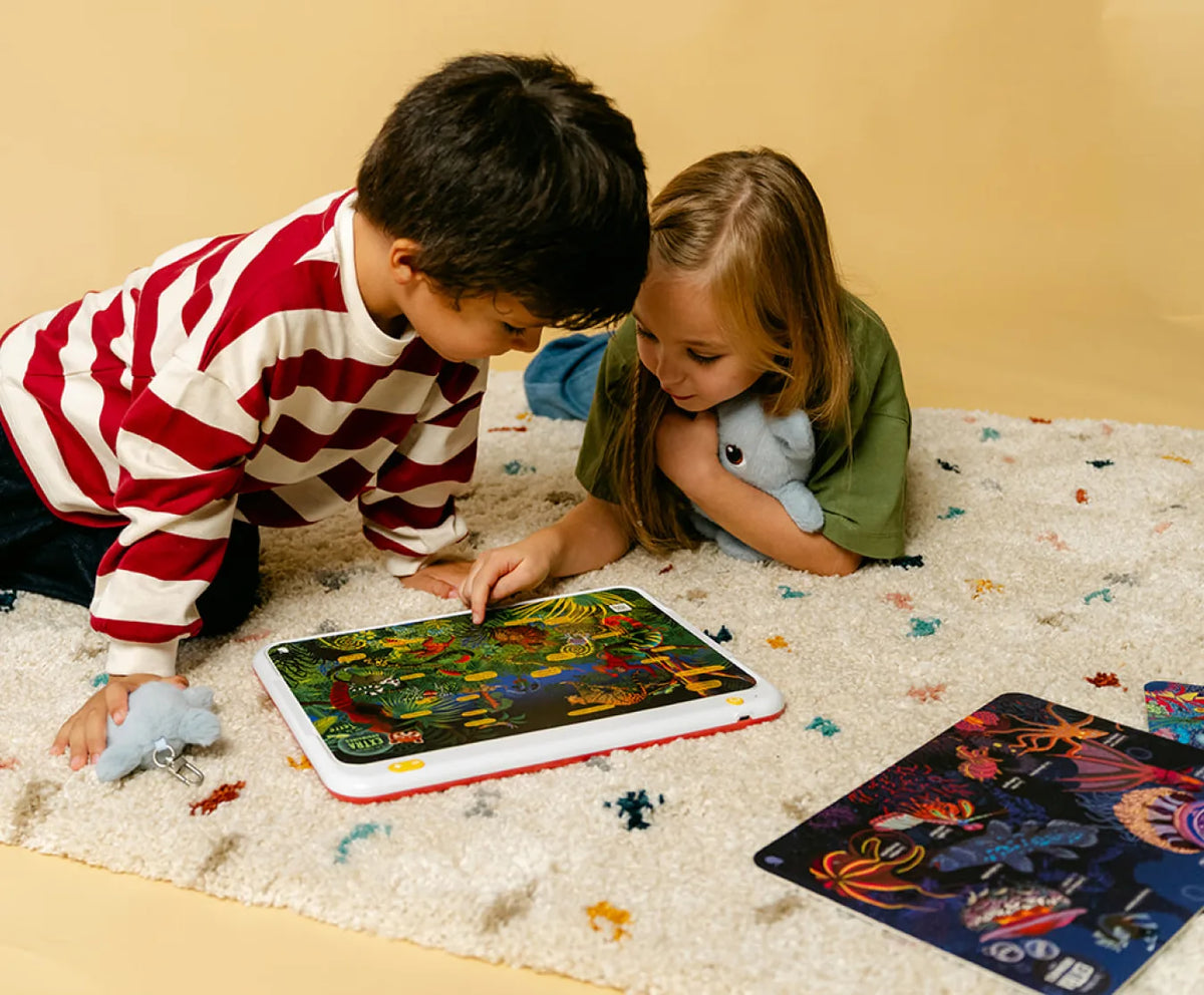 Deux enfants jouent avec une carte interactive posée sur HopiPlay